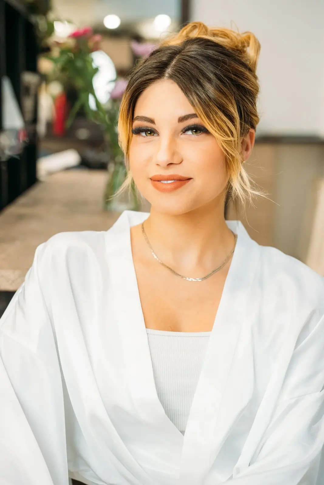Soft neutral eye makeup and a warm lip with a bridal updo.