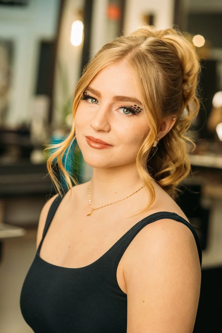 Formal makeup with defined lashes and a soft warm lip.