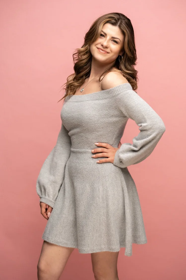 Natural-looking portrait makeup in a grey-dress studio portrait.